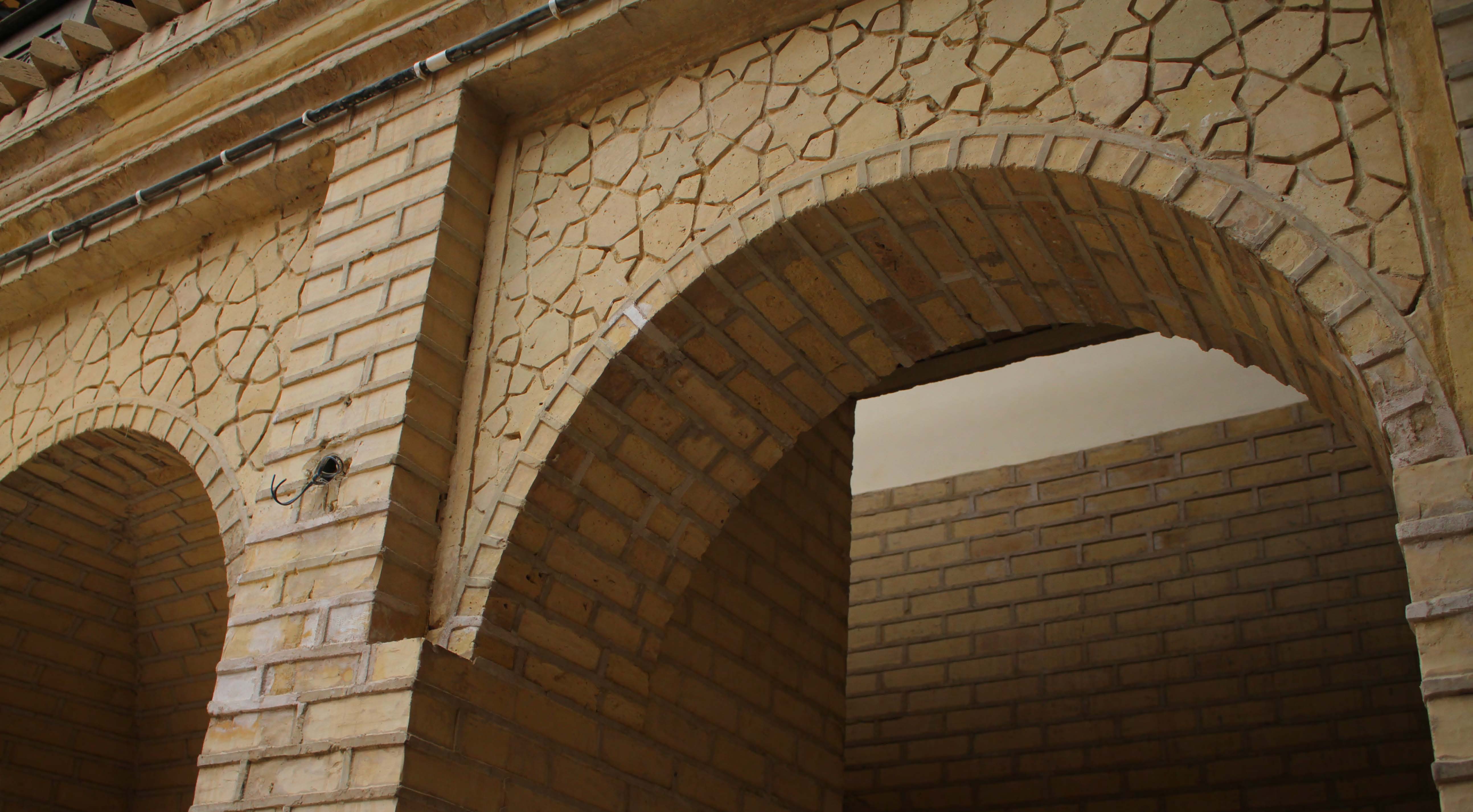 Heritage brick archway with geometric plaster patterns